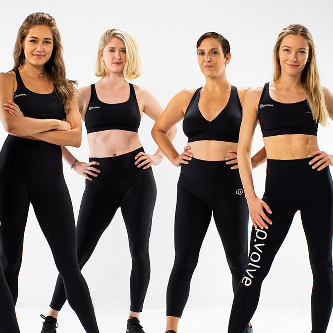 Group of P.volve trainers in athletic wear pose with hands on hips