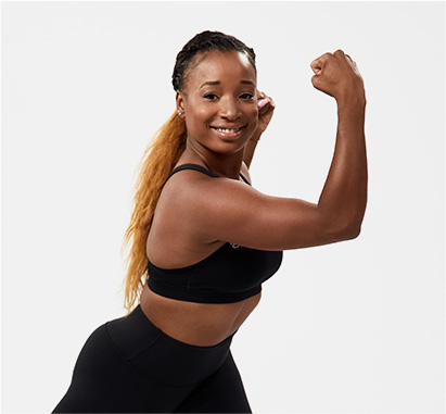Muscular woman smiles while performing a proprietary movement