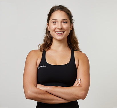 Trainer wearing P.volve athletic wear smiles