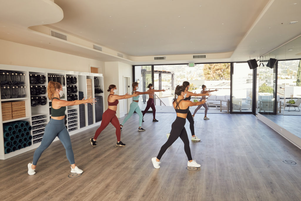 Group of women doing a P.volve workout in a modern, well-lit gym