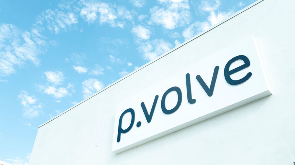 Photo of the top of a P.volve studio with P.volve logo and blue sky