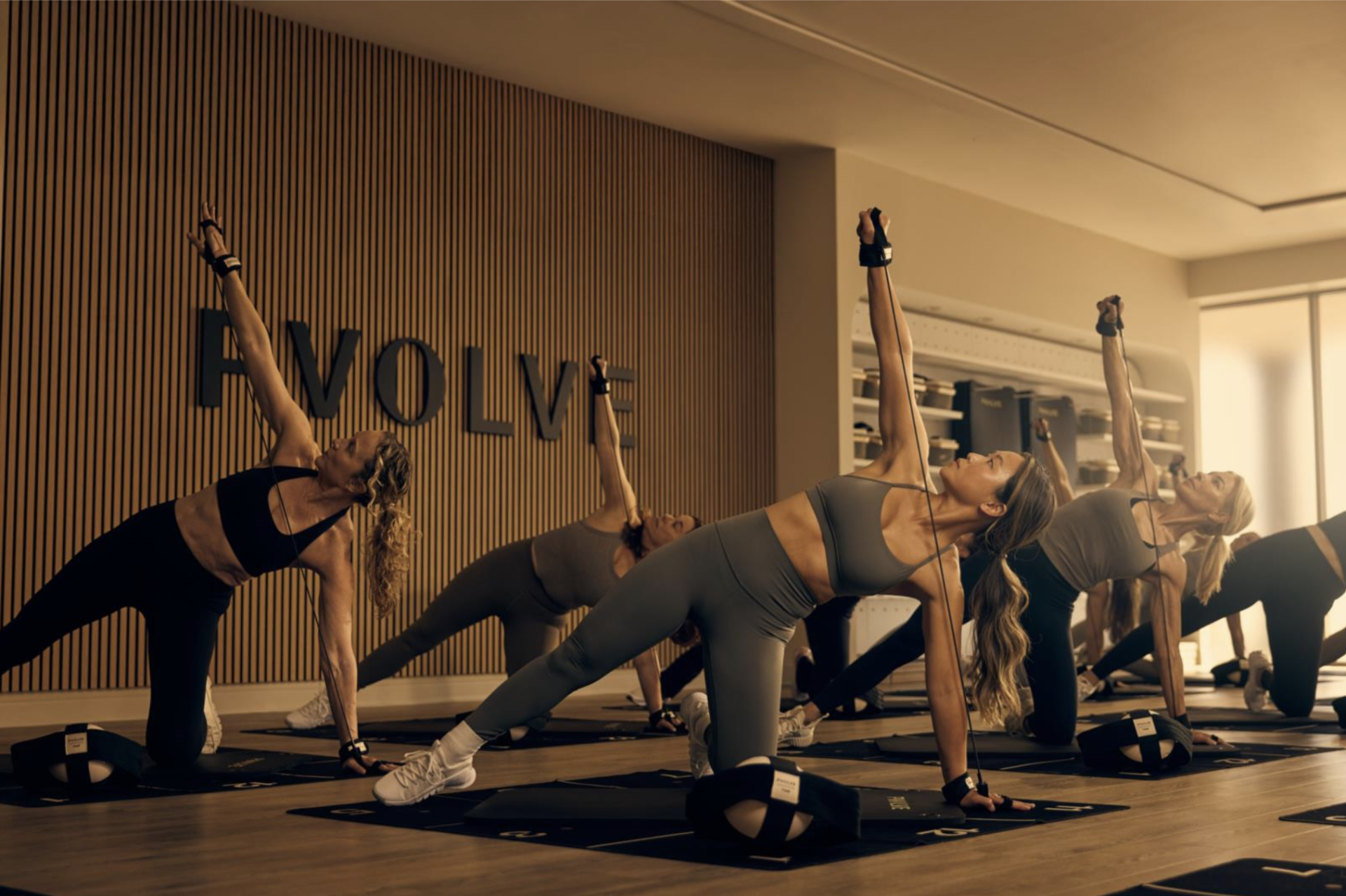 women in a PVOLVE fitness studio all doing an exercise